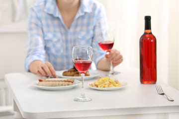 Dinner with glass of wine indoors