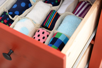 Folded clothes in chest of drawers closeup