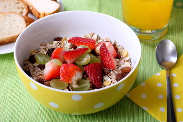 Healthy colorful breakfast: cereals with fresh fruits and fresh orange juice