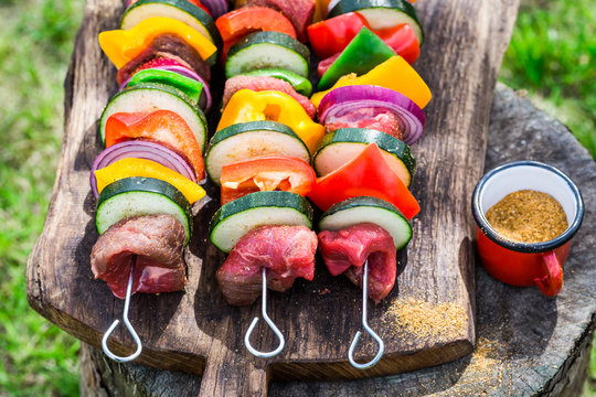 Fresh red meat and vegetables with herbs on grill