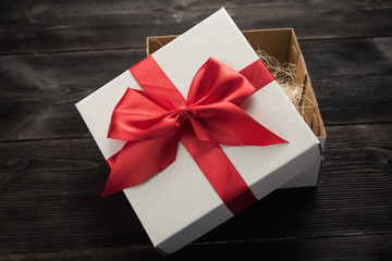 white gift box with red ribbon