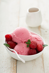 Raspberry ice cream in white bowl