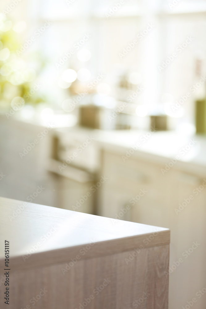 Sticker light wooden kitchen table on blurred background, close up