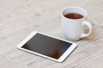 Fototapeta na wymiar cup of coffee, smart phone and tablet