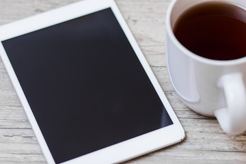 Fototapeta na wymiar cup of coffee, smart phone and tablet