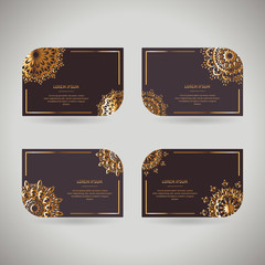 Set of four ornamental gold cards with flower oriental mandala on dark background. Ethnic vintage pattern. Indian, asian, arabic, islamic, ottoman motif. Vector illustration under clipping mask.