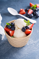 Vanilla ice cream scoops with berries