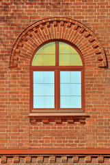 Window with an arch on the background wall of red brick. From the series window of Saint-Petersburg.