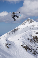 Fototapeta na wymiar Flying snowboarder on mountains. Extreme sport.