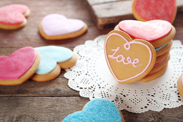 Colorful Valentine heart cookies on wooden background