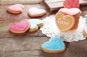 Colorful Valentine heart cookies on wooden background