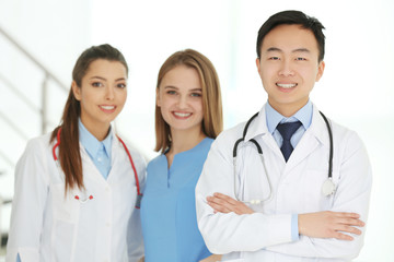 Fototapeta premium Team of smiling doctors indoors