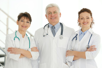 Team of smiling doctors indoors