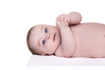 adorable baby with blue eyes lying on back