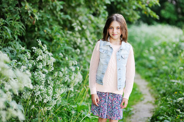 Portrait of a cute little girl outside