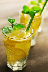 Group of lemonades with lemon and mint on wooden table background