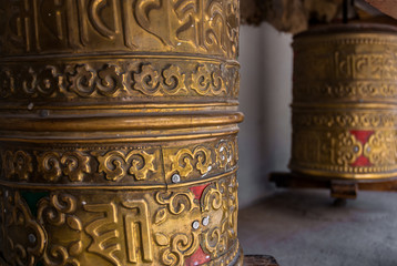 Leh, India - AUGUST 21, 2007: Stationary prayer wheels near Buddhist monastery. Traditionally the mantra Om Mani Padme Hum is written in Sanskrit on the wheel and believers spin it clockwise.