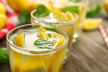 Composition of lemonades,  lemons and mint on wooden table background, closeup
