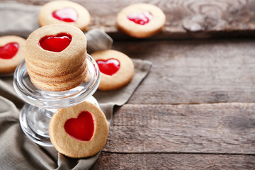 Love cookies with grey cloth on wooden background, closeup