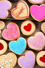 Assortment of love cookies on wooden background, closeup