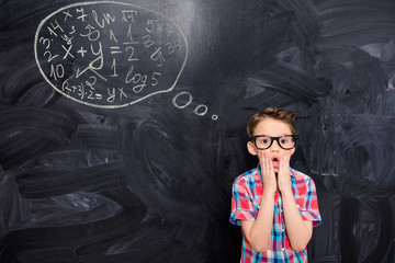 Little smart boy thinking about solving hard equation