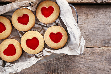 Tray with love cookies on wooden background