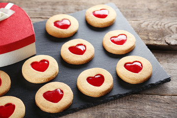 Assortment of love cookies with gift box on grey stand