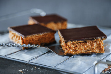 Tasty homemade cakes with chocolate on dark background, close up
