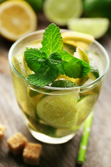 Fresh mojito drink with lime, lemon and mint, closeup