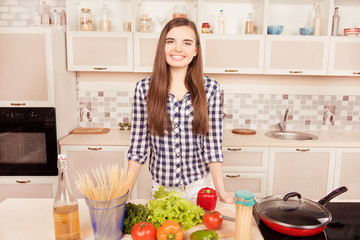 Attractive young woman posing in the kitchen and going to make d