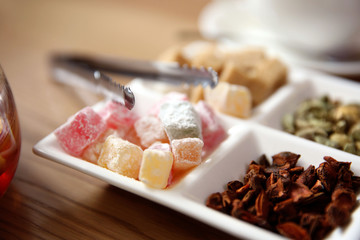 Plate with different sugar and spices on table in cafe or restaurant