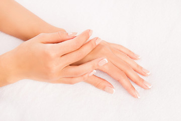 Close up photo of woman's hand with manicure on white background