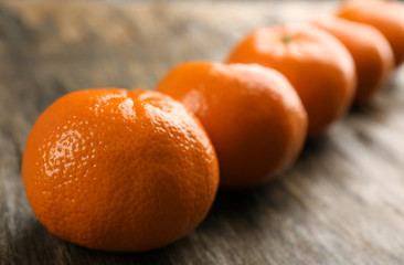 Fresh, delicious tangerines on a rustic table, close up