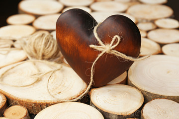 Brown heart with rope on wood log background