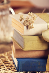 Stack of old books tied with yellow ribbon on a table, close up