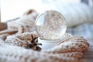 Snow globe with woolen scarf, close up