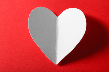 Beautiful paper heart on dark red background