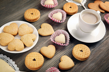 Valentine concept. Composition of cup, cookies and candies on blue background
