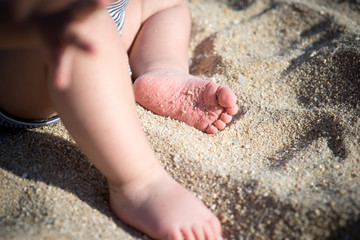 Baby feet playing in sand