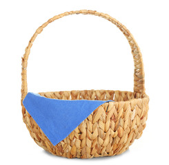Wicker basket with blue napkin isolated on white