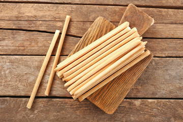 Stack of bread sticks on wooden table