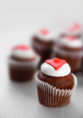 Cupcakes on plate on a light wooden background