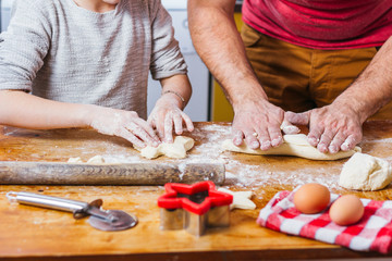 Father and daughter making dough
