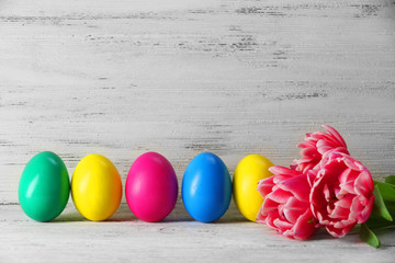 Colorful Easter eggs on wooden background