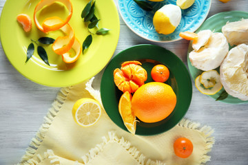 Fototapeta na wymiar Fresh citrus fruits on the plates