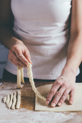 Woman making pasta from dough