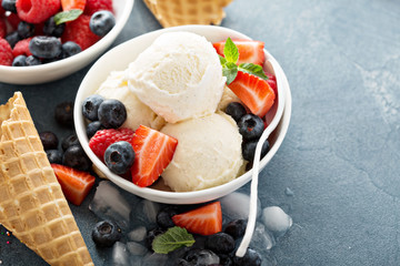 Vanilla ice cream scoops with berries