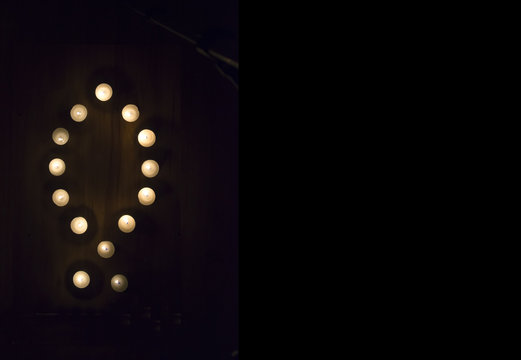 Candles in Ichthys motif on hardwood floor