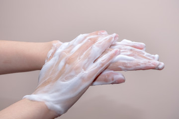 Women washing of hands with soap foam ,nice soft background