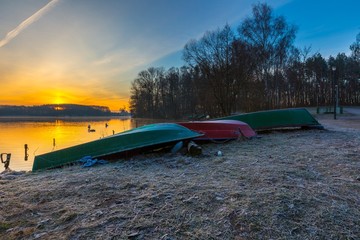 Lake shore with fisherman's boats in colorful landscape